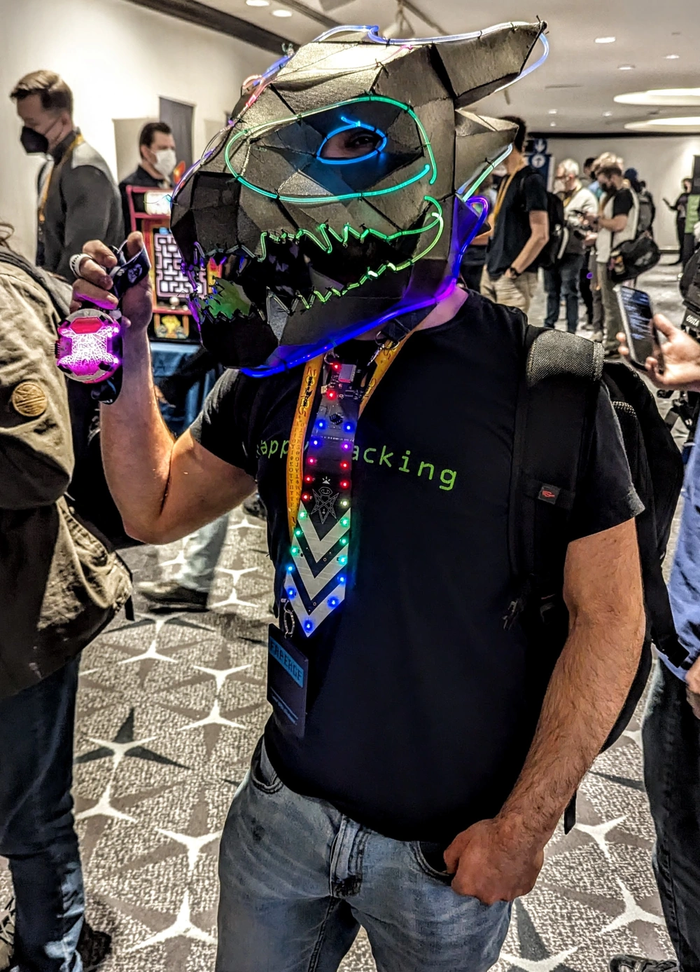 Hardware dinosaur head with LED strips, hardware tie with LEDs and holding a hardware badge